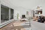 This stunning living space boasts a bright and airy ambiance, perfect for modern living.