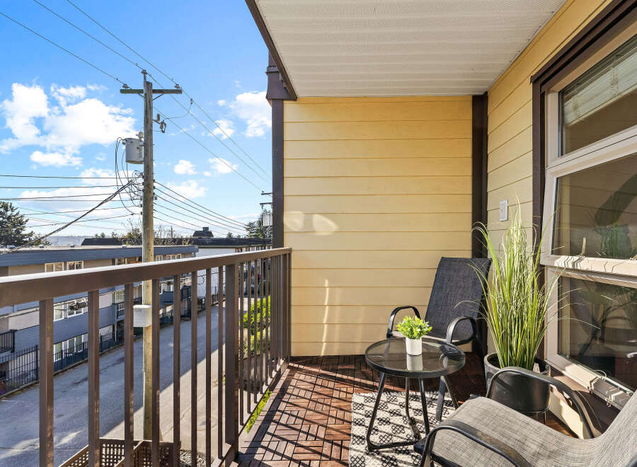 Enjoy the fresh air and stunning views from this charming balcony.