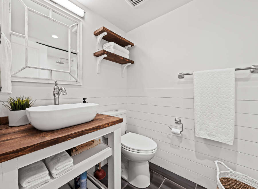 This stunning bathroom boasts a modern farmhouse aesthetic, perfect for a relaxing retreat.
