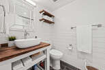This stunning bathroom boasts a modern farmhouse aesthetic, perfect for a relaxing retreat.