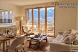 Experience the epitome of alpine living in this stunning property, showcasing breathtaking mountain views through expansive windows.