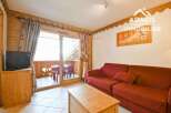 Discover the charm of this cozy property, featuring a comfortable living area with a stylish red sofa.