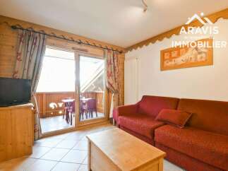 Discover the charm of this cozy property, featuring a comfortable living area with a stylish red sofa.