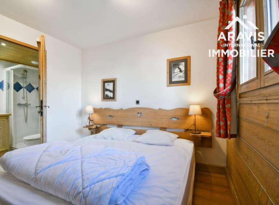 Discover this charming bedroom featuring a cozy bed, perfect for relaxation.