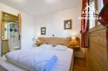 Discover this charming bedroom featuring a cozy bed, perfect for relaxation.