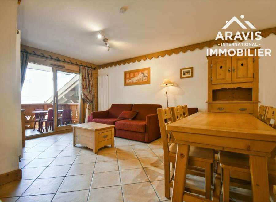 Discover a cozy living space with a charming wooden dining table and chairs, perfect for family gatherings.