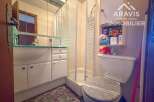 Discover this well-maintained bathroom featuring a modern shower enclosure and a sleek vanity.