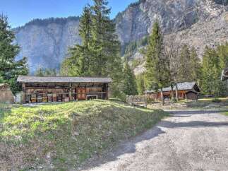 Nestled in a serene mountain setting, this charming property offers a unique blend of rustic charm and natural beauty.