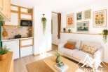 Discover this charming studio apartment featuring a compact, well-equipped kitchenette with modern appliances and ample storage.