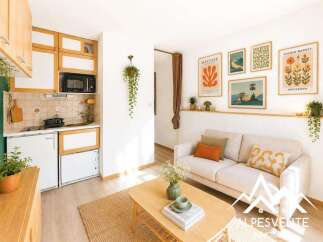 Discover this charming studio apartment featuring a compact, well-equipped kitchenette with modern appliances and ample storage.