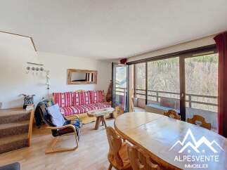Discover this charming property featuring a cozy living area with a comfortable sofa and a dining space perfect for gatherings.