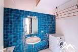 Discover this charming property featuring a modern laundry room with a washing machine and a convenient clothes drying rack.