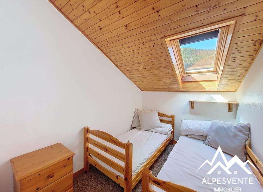 This cozy bedroom features two single beds, perfect for a guest room or a children's room.