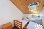 This cozy bedroom features two single beds, perfect for a guest room or a children's room.