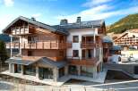 Discover the charm of this stunning chalet-style property, boasting a perfect blend of wood and stone architecture.