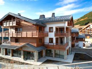 Discover the charm of this stunning chalet-style property, boasting a perfect blend of wood and stone architecture.