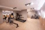 This modern gym offers a comprehensive workout experience with a variety of equipment.