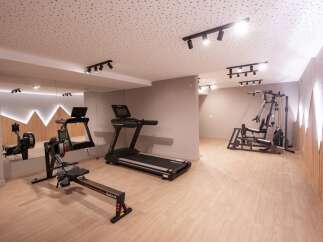 This modern gym offers a comprehensive workout experience with a variety of equipment.