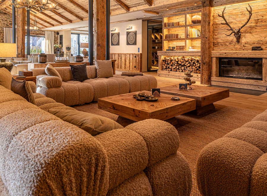 Experience luxury living in this stunning property, featuring a cozy living room with a plush, inviting sofa.