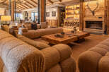 Experience luxury living in this stunning property, featuring a cozy living room with a plush, inviting sofa.