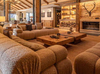 Experience luxury living in this stunning property, featuring a cozy living room with a plush, inviting sofa.