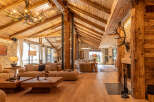 Experience rustic luxury in this stunning property, featuring exposed wooden beams, stone walls, and a cozy fireplace.
