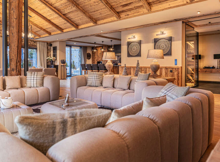 Experience luxury living in this stunning property featuring a spacious living room with plush seating and a cozy fireplace.