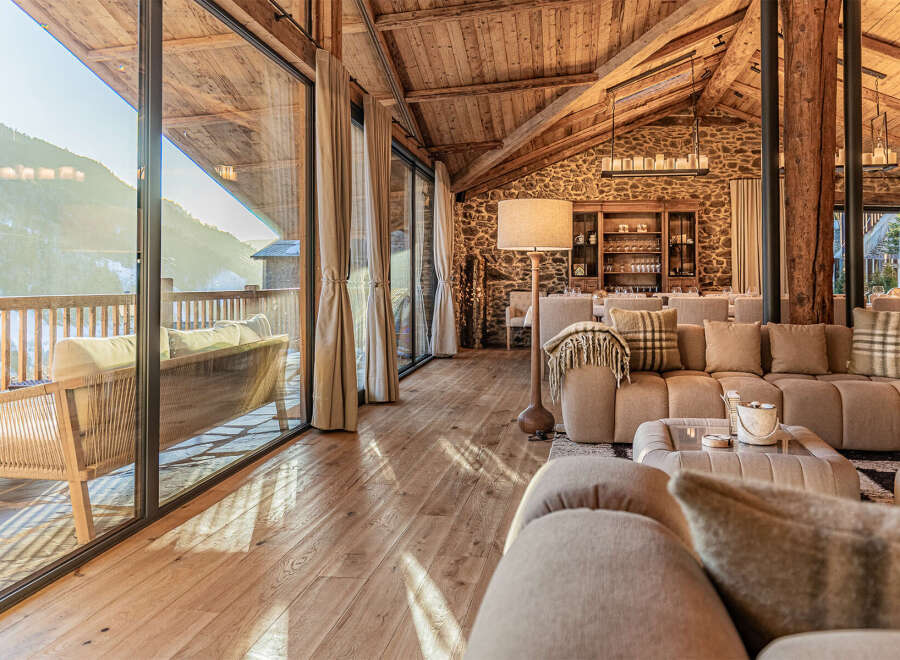 Experience luxury living in this stunning property, featuring a spacious living area with a cozy sofa and a beautiful wooden floor.