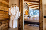 Step into luxury with this stunning property, showcasing a cozy bedroom with a breathtaking mountain view.