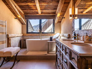 Indulge in the epitome of luxury with this stunning bathroom, featuring a freestanding tub and a vanity with double sinks.