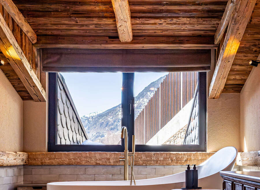 Experience luxury living in this stunning property, featuring a spa-like bathroom with breathtaking mountain views.