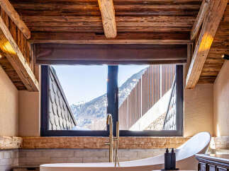 Experience luxury living in this stunning property, featuring a spa-like bathroom with breathtaking mountain views.