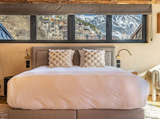 Experience luxury living with this stunning property, boasting breathtaking mountain views visible from the bedroom's expansive windows.