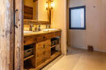 This stunning bathroom boasts a rustic, yet modern design, perfect for a luxurious retreat.