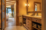 Experience luxury living in this stunning property, featuring a beautifully designed bathroom with rustic wooden accents and modern amenities.