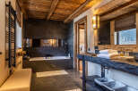 Experience luxury in this stunning bathroom featuring a sleek, modern design with a rustic touch.