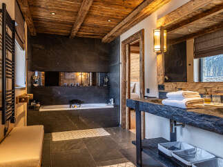 Experience luxury in this stunning bathroom featuring a sleek, modern design with a rustic touch.