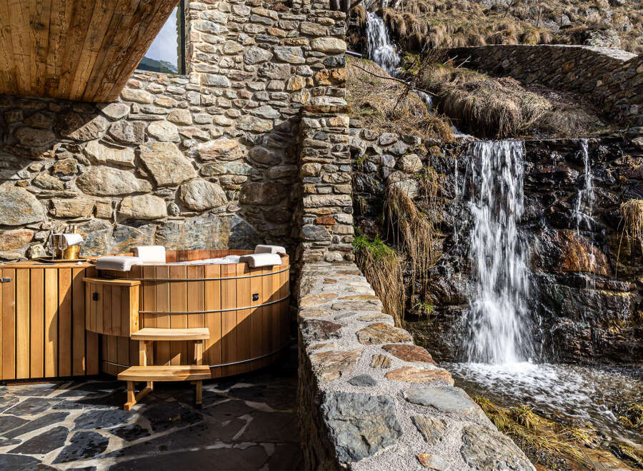 Experience ultimate relaxation in this stunning property featuring a luxurious wooden hot tub.