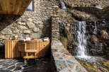 Experience ultimate relaxation in this stunning property featuring a luxurious wooden hot tub.