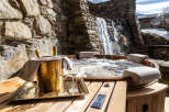 Indulge in luxury and relaxation at this stunning property featuring a private hot tub with a cascading waterfall backdrop.