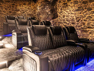 Step into luxury with this stunning home theater! Featuring plush, diamond-stitched leather seating and ambient blue lighting, this space is designed for ultimate comfort and entertainment.