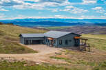Nestled in a serene landscape, this stunning property offers breathtaking mountain views and a tranquil retreat.