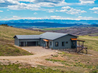 Nestled in a serene landscape, this stunning property offers breathtaking mountain views and a tranquil retreat.