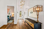 Step into this inviting entryway, showcasing beautiful hardwood floors and stylish lighting fixtures.