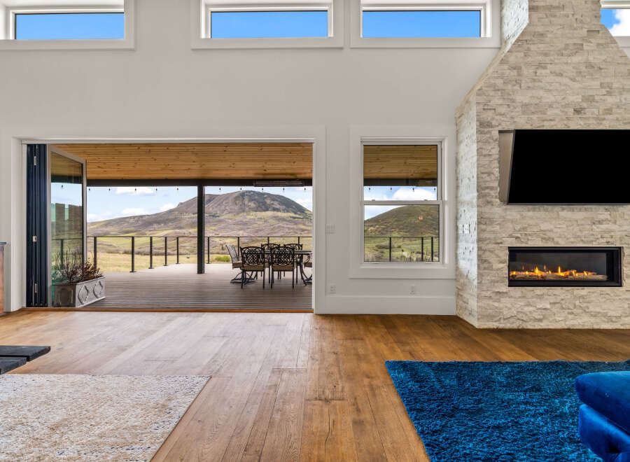 Experience luxury living in this stunning property featuring a modern fireplace and a spacious open-concept design.