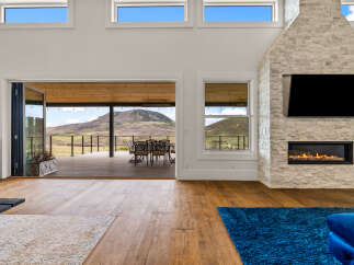 Experience luxury living in this stunning property featuring a modern fireplace and a spacious open-concept design.