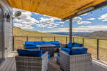 Enjoy breathtaking views from this stunning outdoor living space! This property features a comfortable seating area with a fire pit, perfect for relaxing and entertaining.