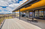 Enjoy breathtaking views from this stunning property featuring a spacious deck, perfect for outdoor entertaining.