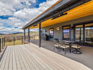 Enjoy breathtaking views from this stunning property featuring a spacious deck, perfect for outdoor entertaining.