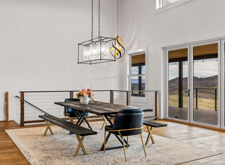 This stunning dining area features a rustic wooden table, perfect for hosting gatherings.